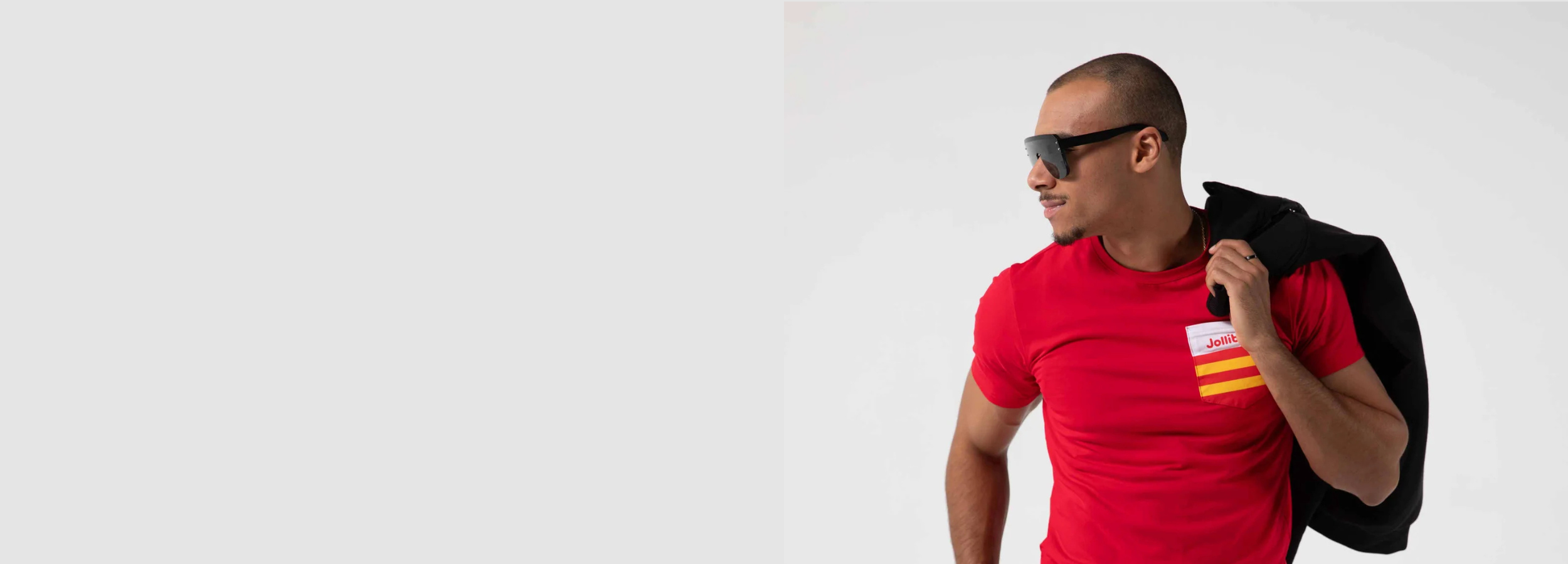 Guy wearing sunglasses and a red t-shirt with striped pocket on chest.