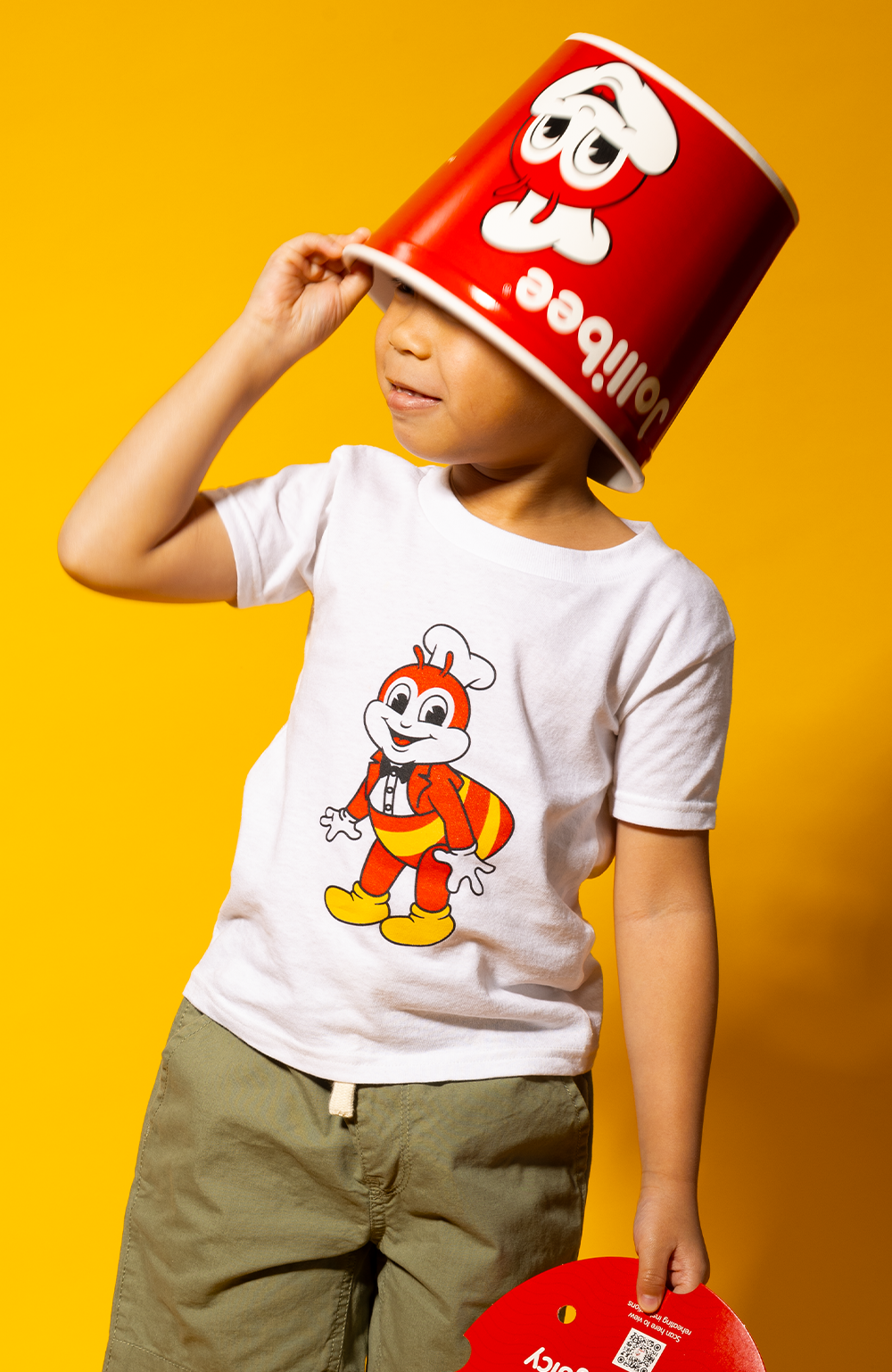 boy wearing the kid mascot white shirt and Jollibee bucket on his head