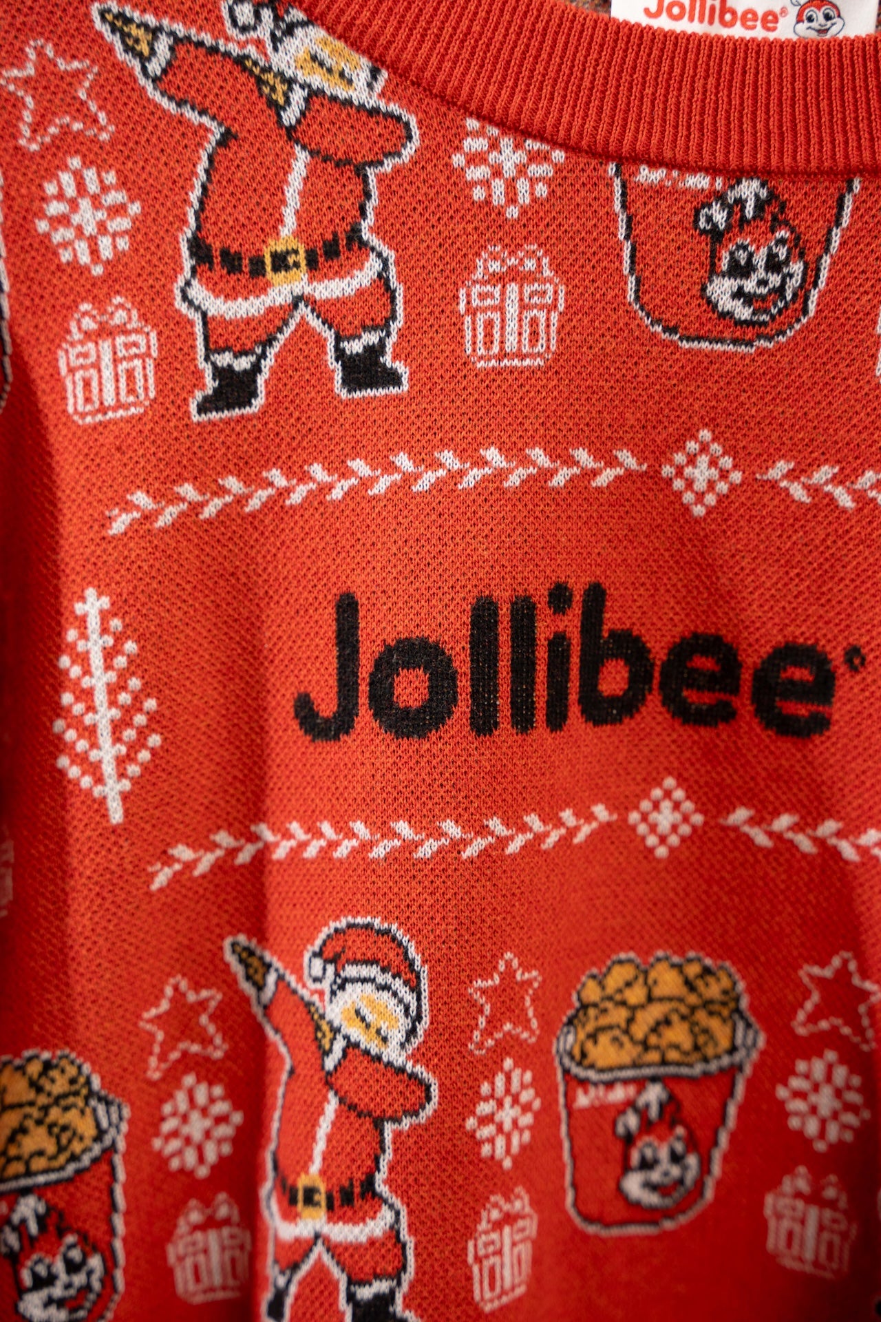 Red sweater with Christmas-themed design and Jollibee branding