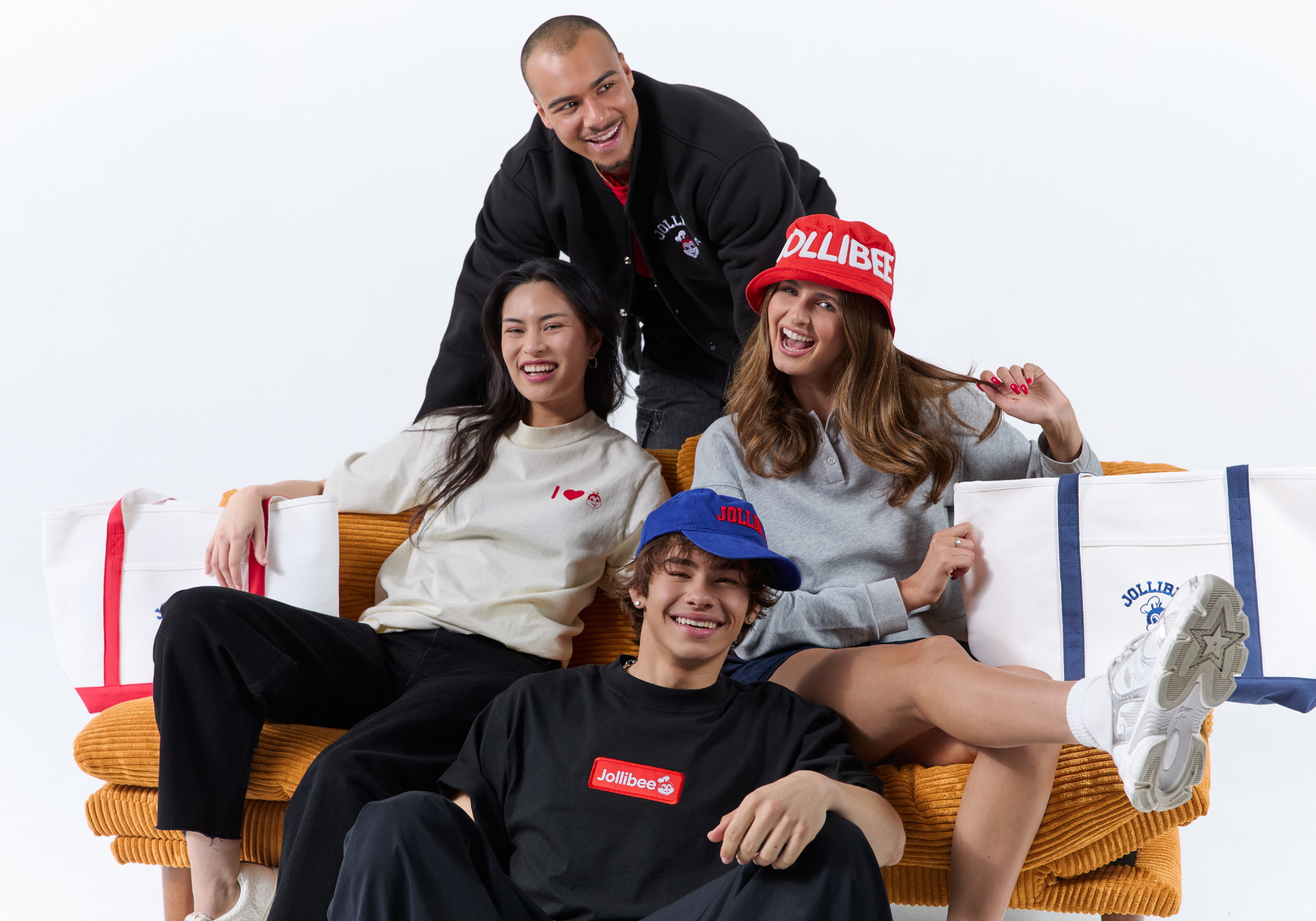 Four people sitting on a couch with visible 'Jollibee' branding.