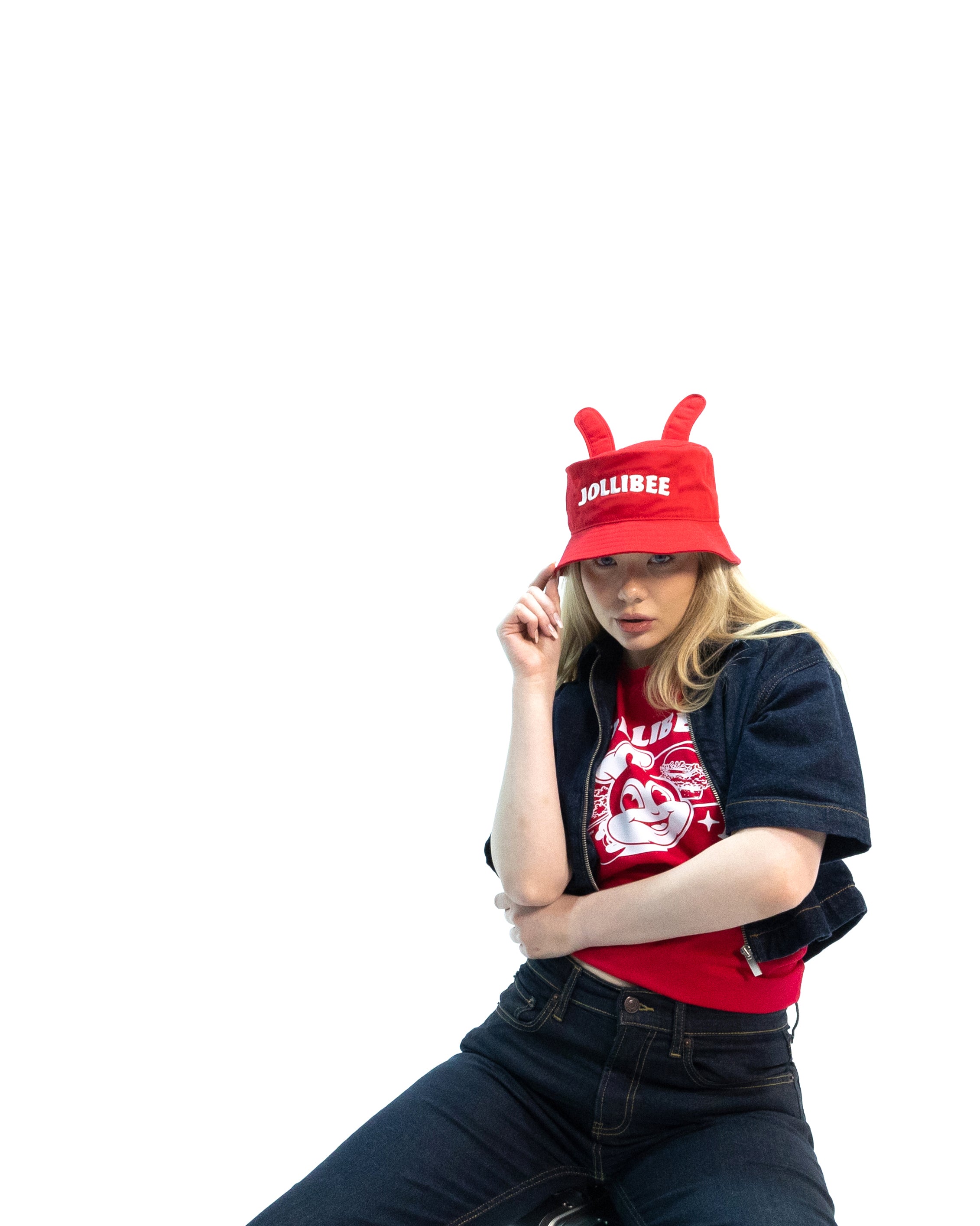Person wearing a red Jollibee hat and shirt on a white background
