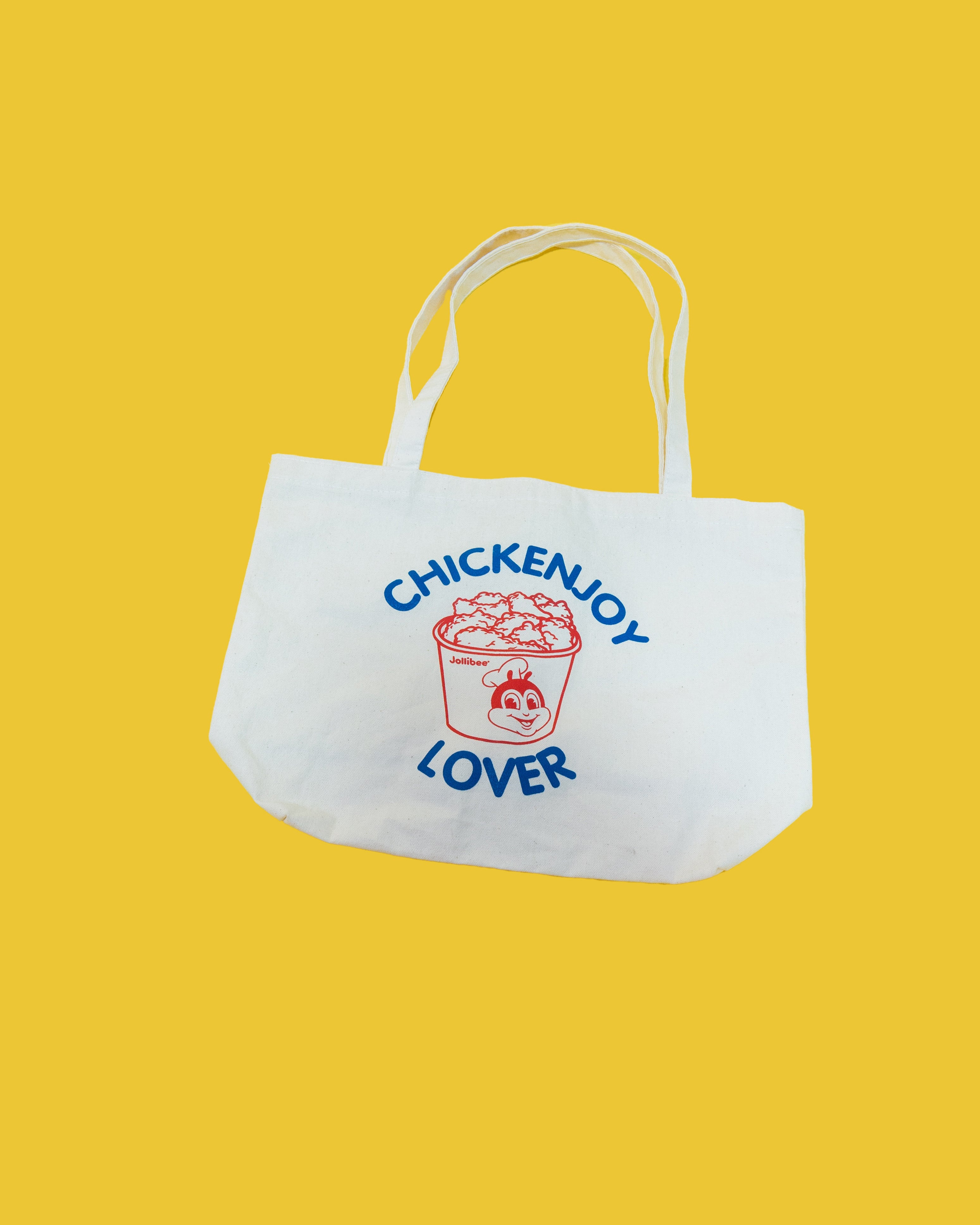 White tote bag with 'CHICKENJOY LOVER' text and graphic on a yellow background
