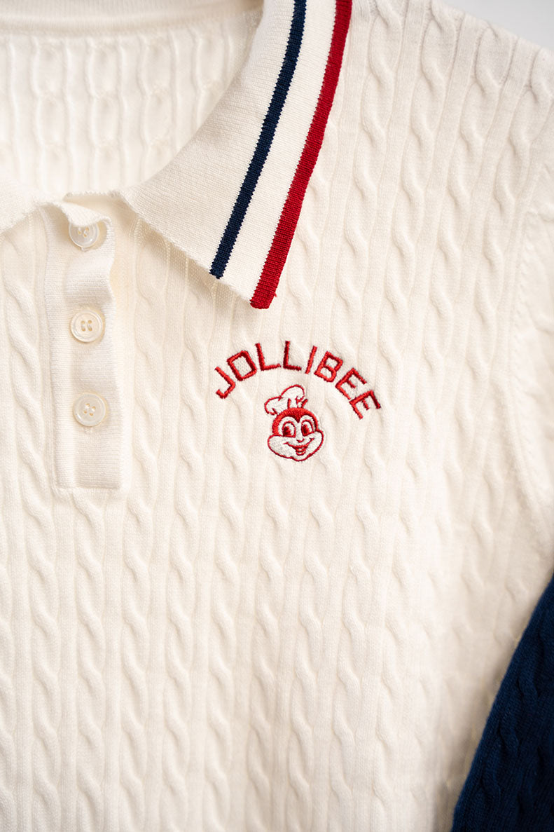 White polo shirt with Jollibee logo and red and blue striped collar