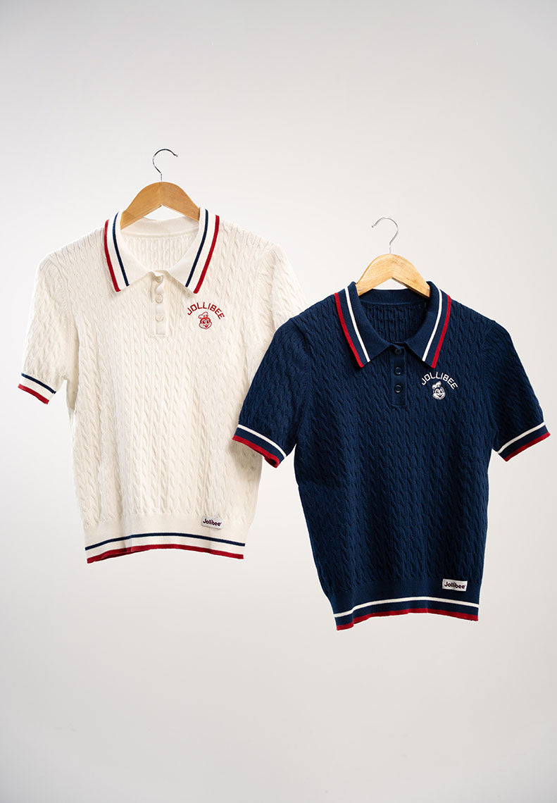 Two polo shirts, one white and one navy, on hangers against a white background.