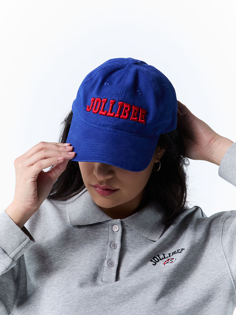 Person wearing a blue cap with 'Jollibee' branding and a matching gray polo shirt.
