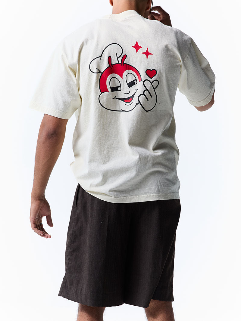Person wearing a white t-shirt with a flirty Jollibee on the back, standing against a white background.