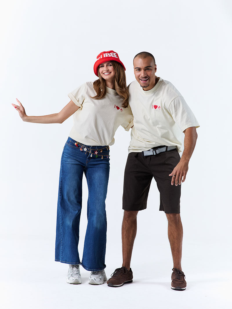 Two people wearing matching t-shirts with a red logo on a white background