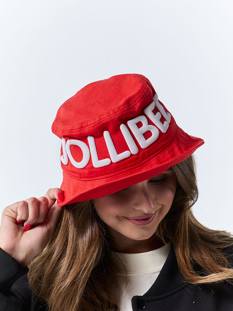 Person wearing a red bucket hat with 'JOLLIBEE' text on a white background