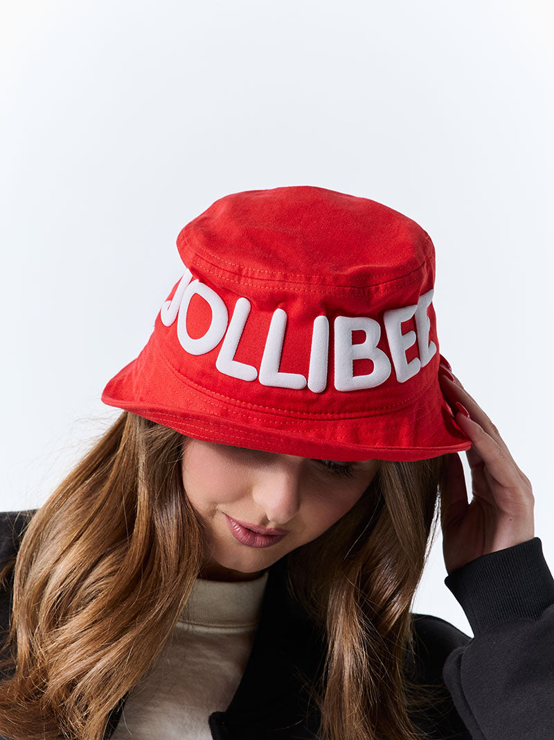 Person wearing a red bucket hat with 'JOLLIBEE' text on a white background