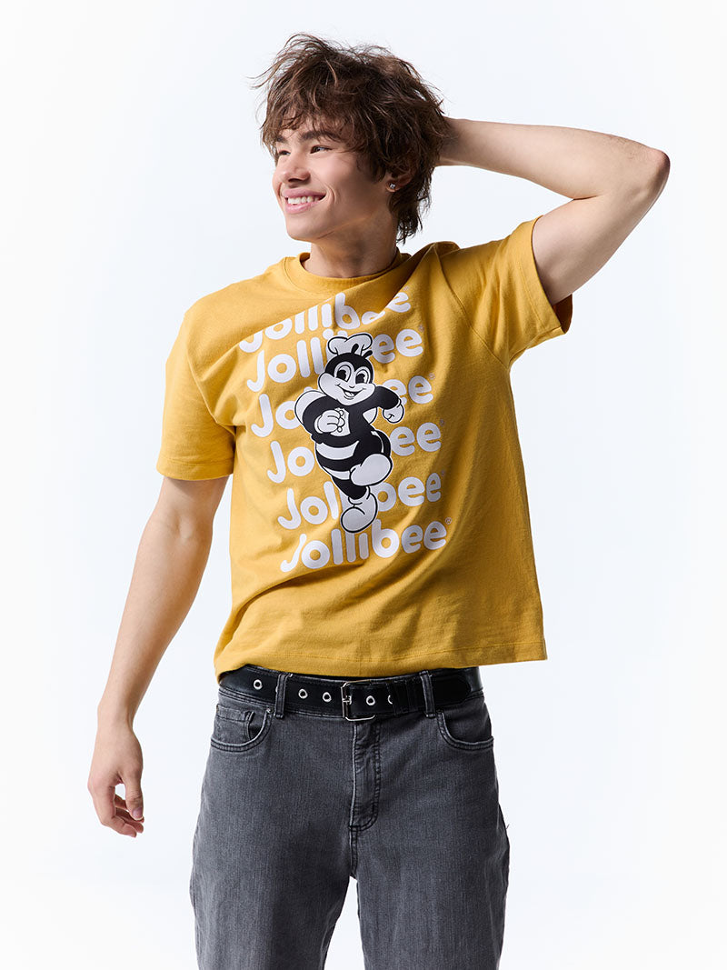 Person wearing a yellow t-shirt with the Jollibee mascot and text on a white background