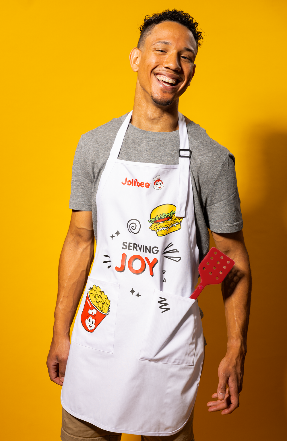 a smiling guy wearing the Jolly White Apron