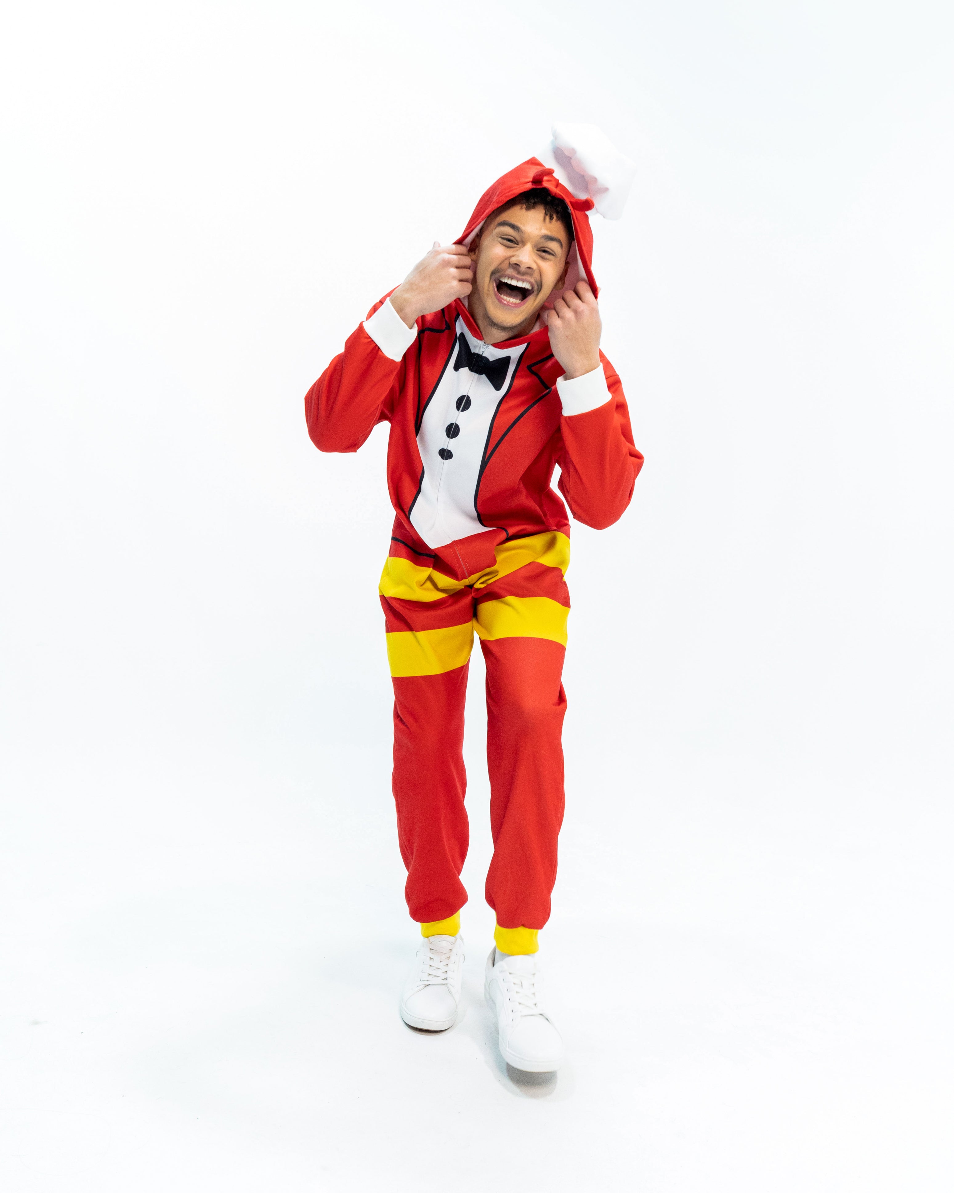 Person wearing a Jollibee red and yellow onesie on a white background