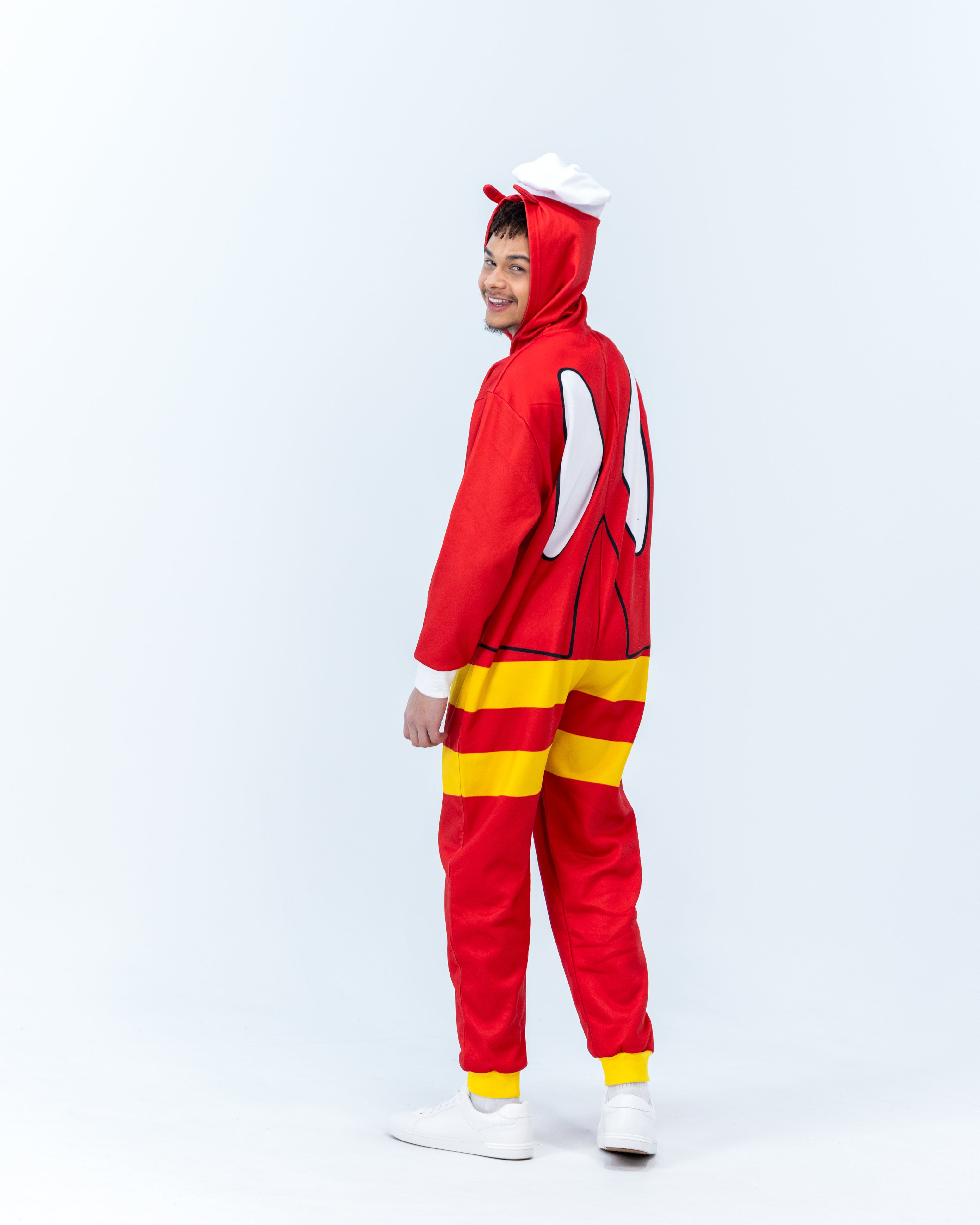 Person wearing a Jollibee red and yellow onesie on a white background