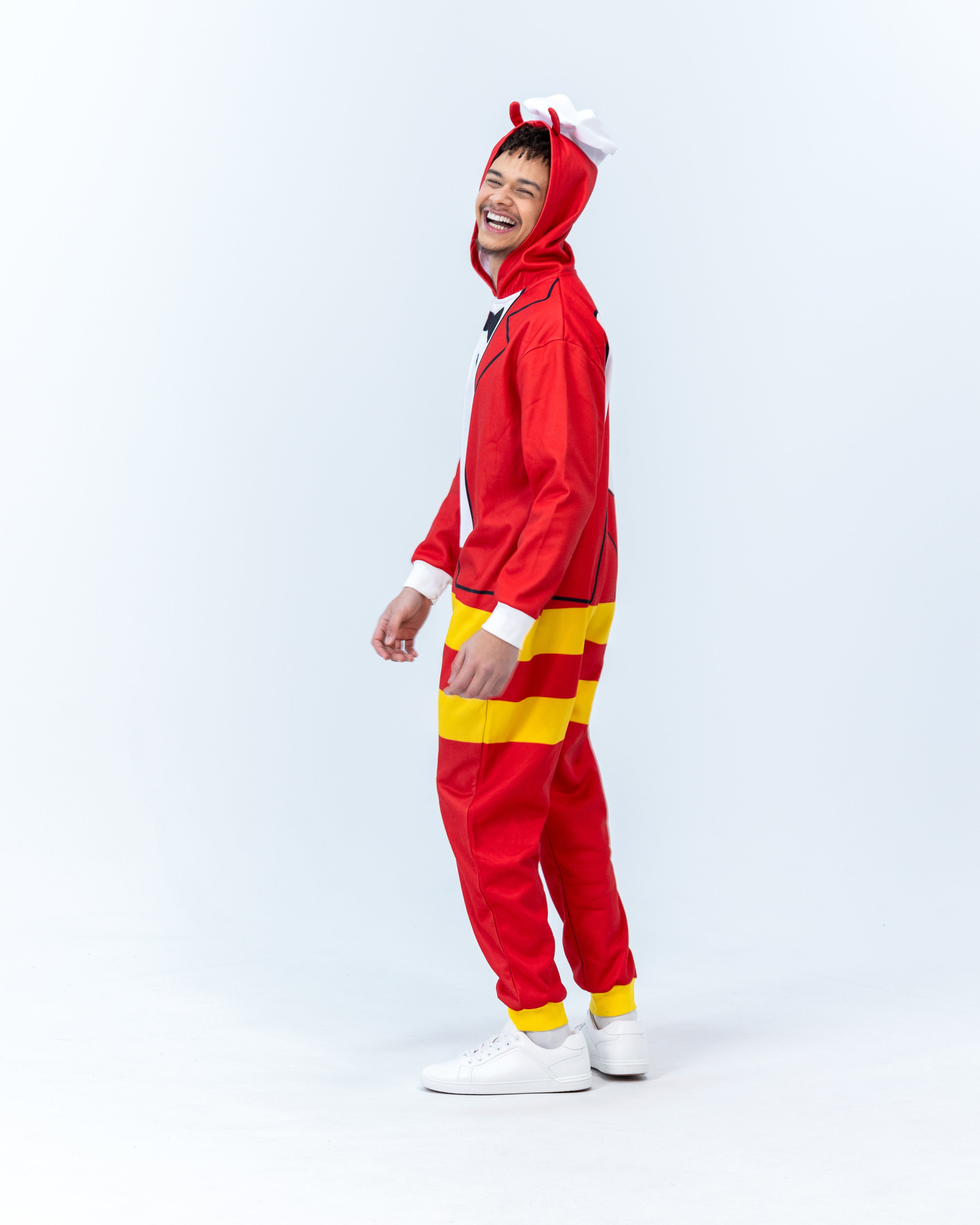 Person wearing a Jollibee red and yellow onesie on a white background
