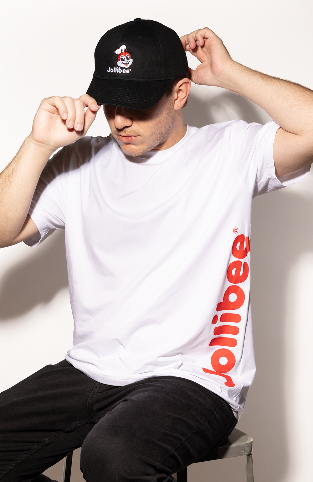 guy wearing the Jollibee Classic White T-Shirt and Black Baseball Cap