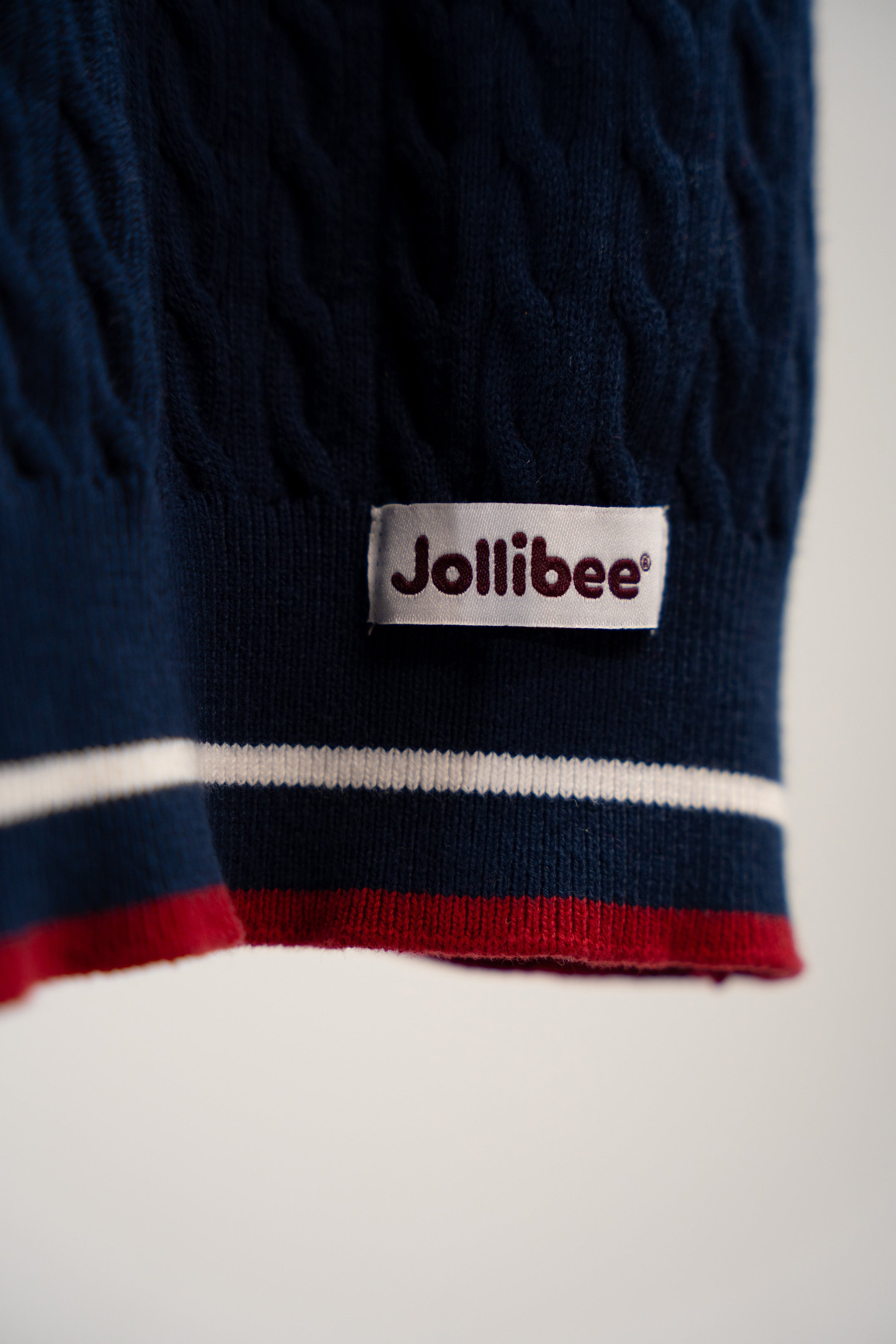 Navy sweater with Jollibee logo on a white background