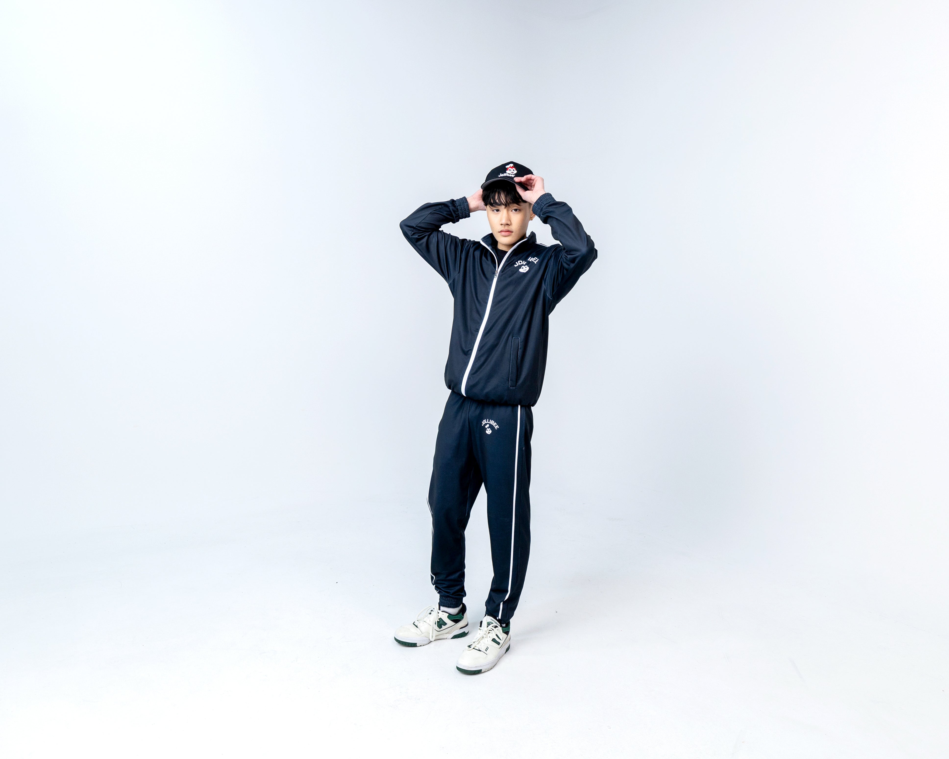 guy wearing Jollibee merch black tracksuit and black baseball cap