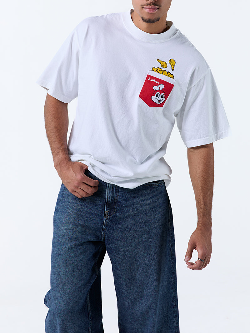 A young man wearing a white t-shirt with a red pocket on the left chest, with a Jollibee logo and fried chicken design on a white background.