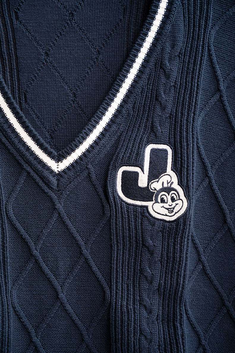 Navy blue sweater with a Jollibee white logo on a textured fabric background