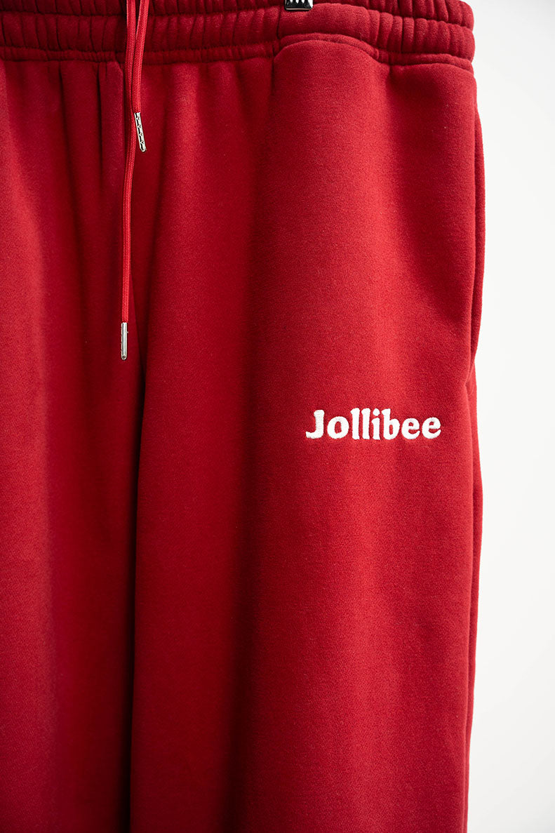 Red sweatpants with 'Jollibee' logo on a white background
