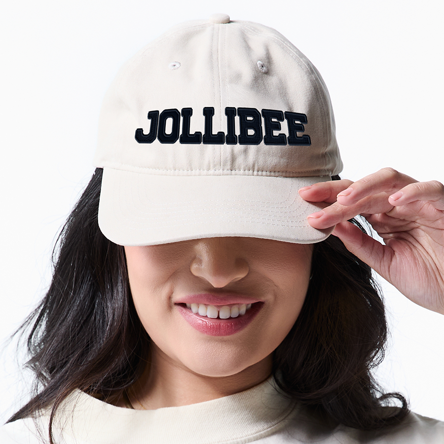 Person wearing a beige cap with 'JOLLIBEE' text on a white background
