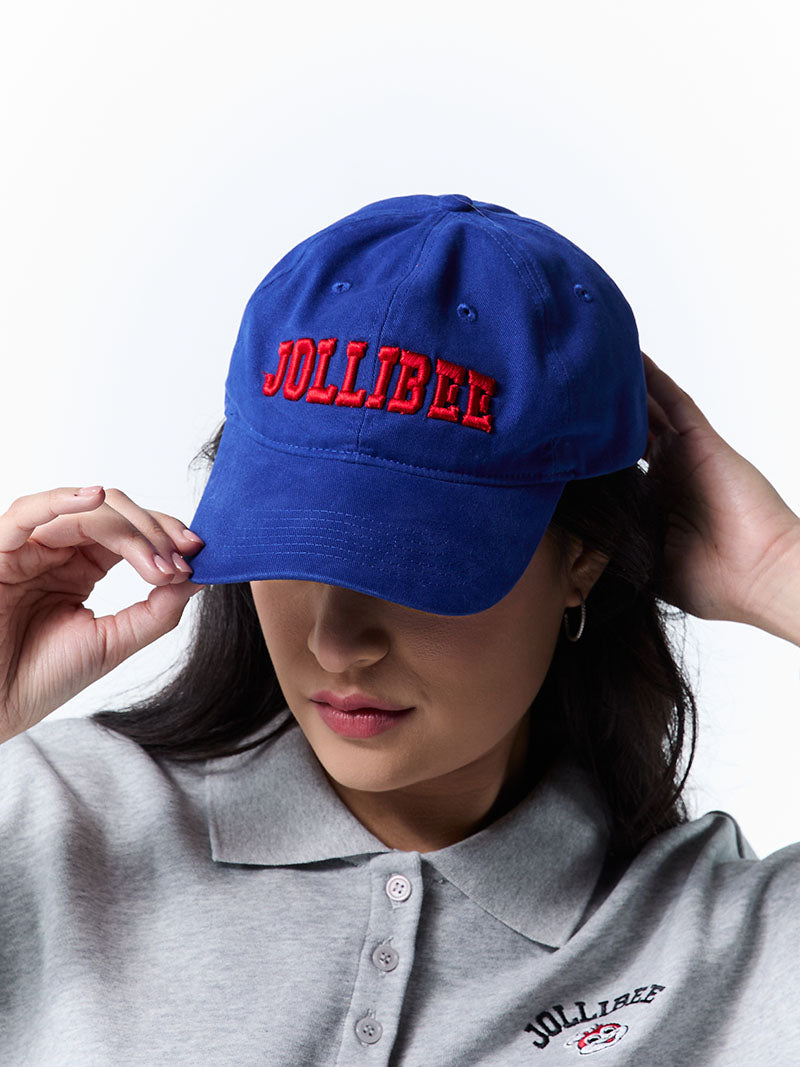 Person wearing a blue cap with 'Jollibee' branding on a white background
