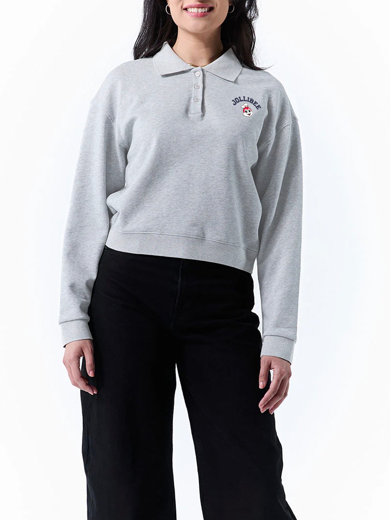 Person wearing a gray sweater with a Jollibee logo on a white background