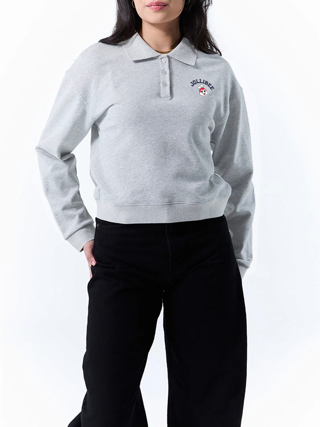 Person wearing a gray collared sweatshirt with a Jollibee logo on a white background