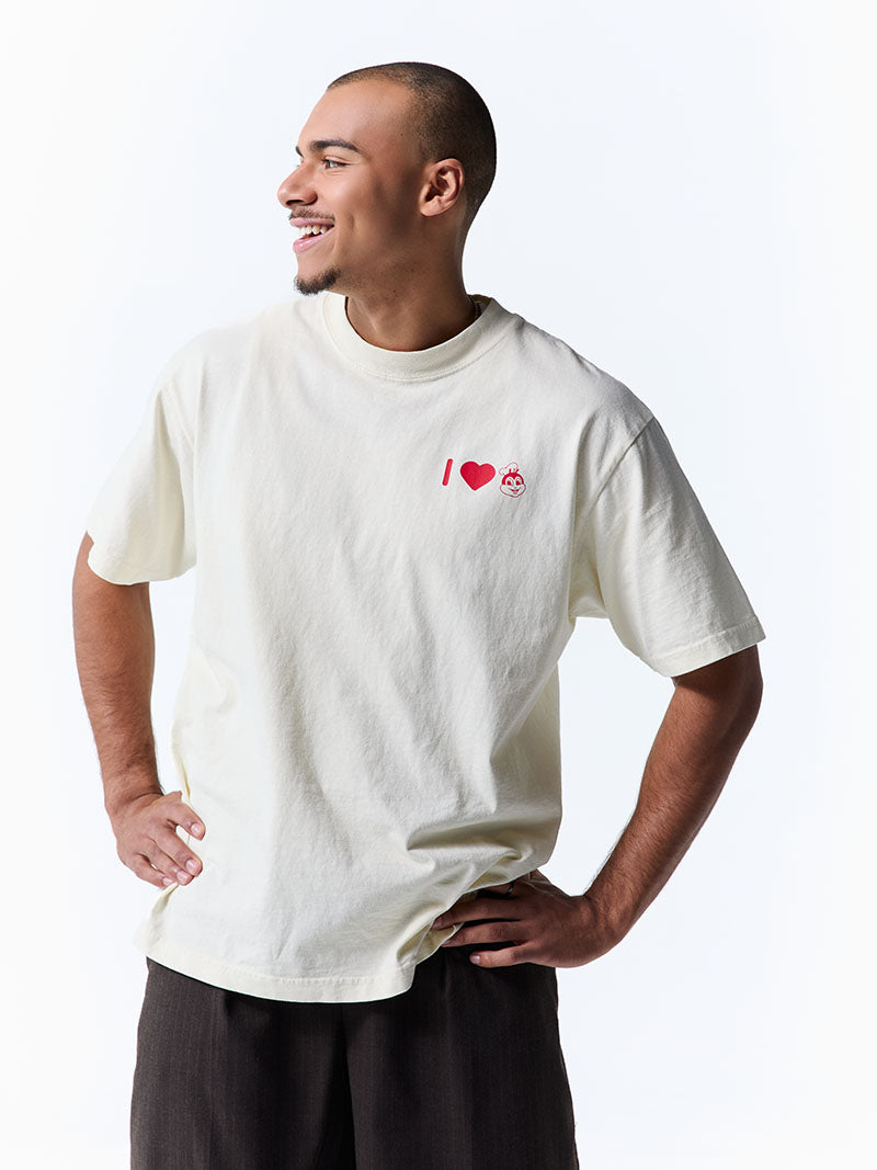 Man wearing a white t-shirt with a graphic design on a plain background