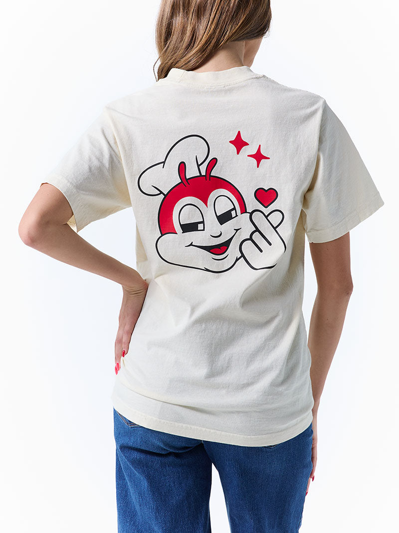 Person wearing a white t-shirt with a flirty Jollibee on the back, standing against a white background