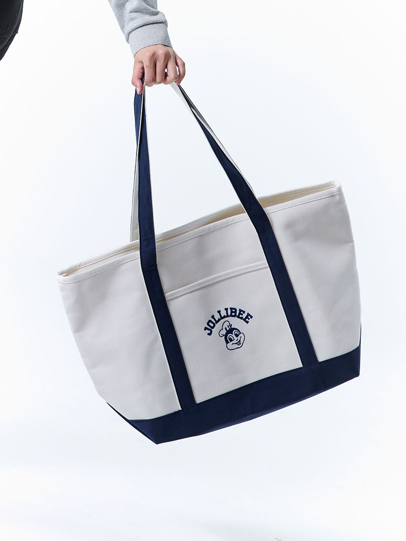 White tote bag with navy handles and Jollibee logo on a white background
