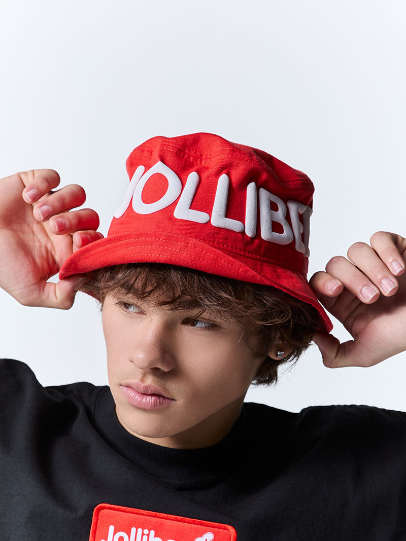 Person wearing a red bucket hat with 'JOLLIBEE' branding against a white background.