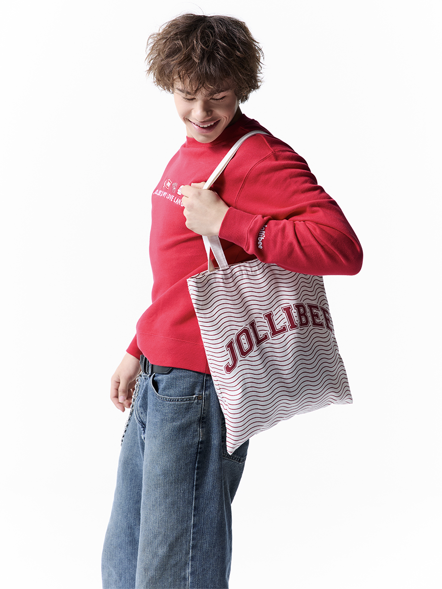 Person holding a Jolliber tote bag against a white background