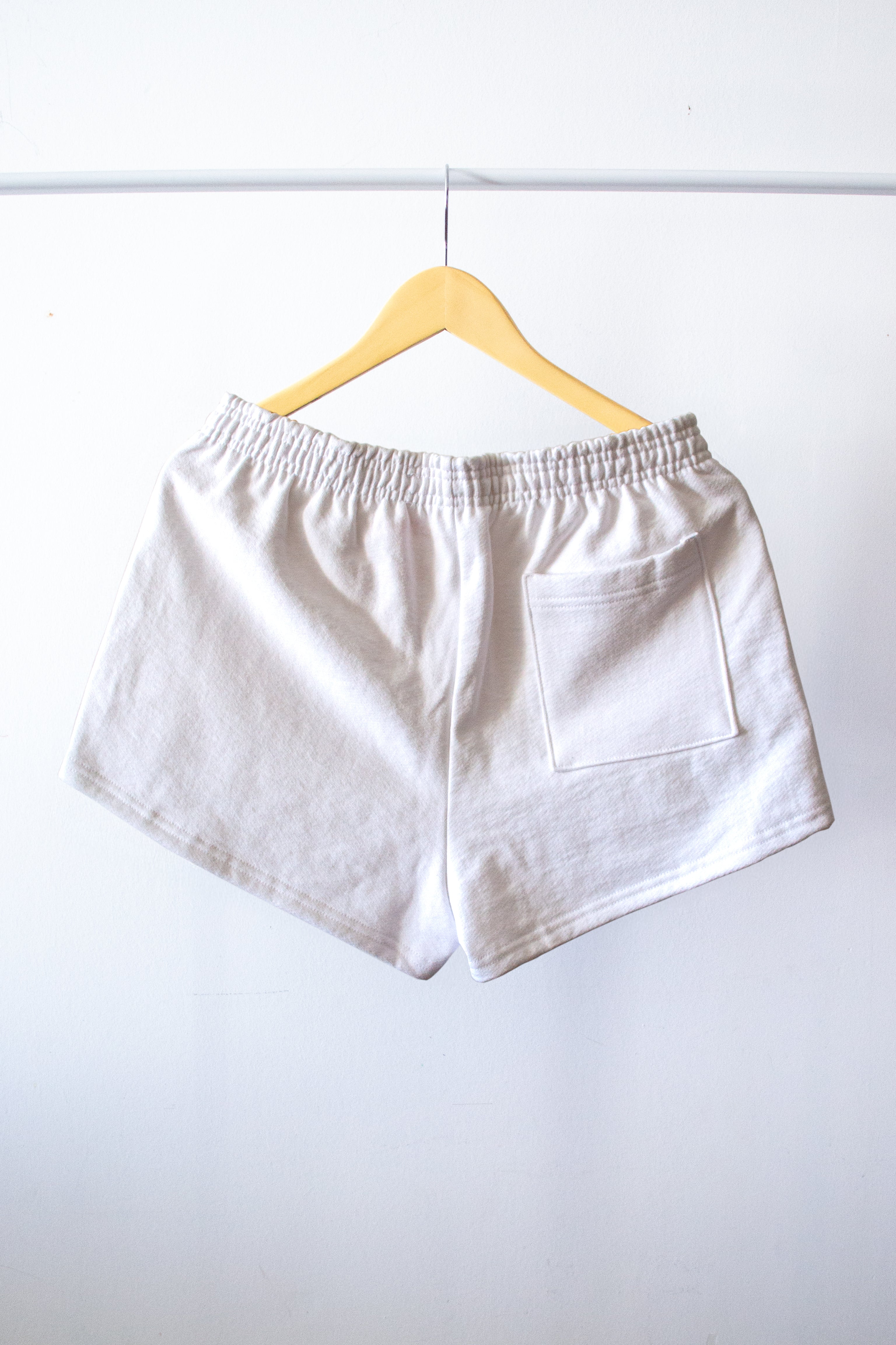 the back of the white shorts on a hanger
