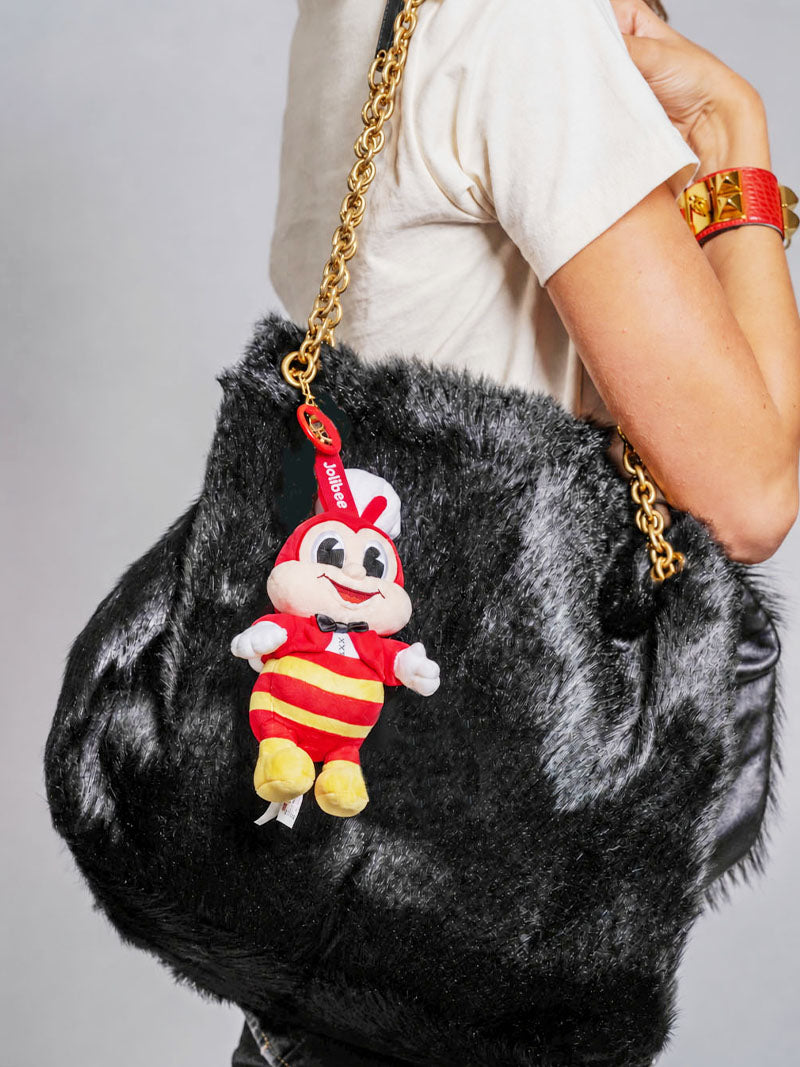 Jollibee Charm on top of a gray bag. 