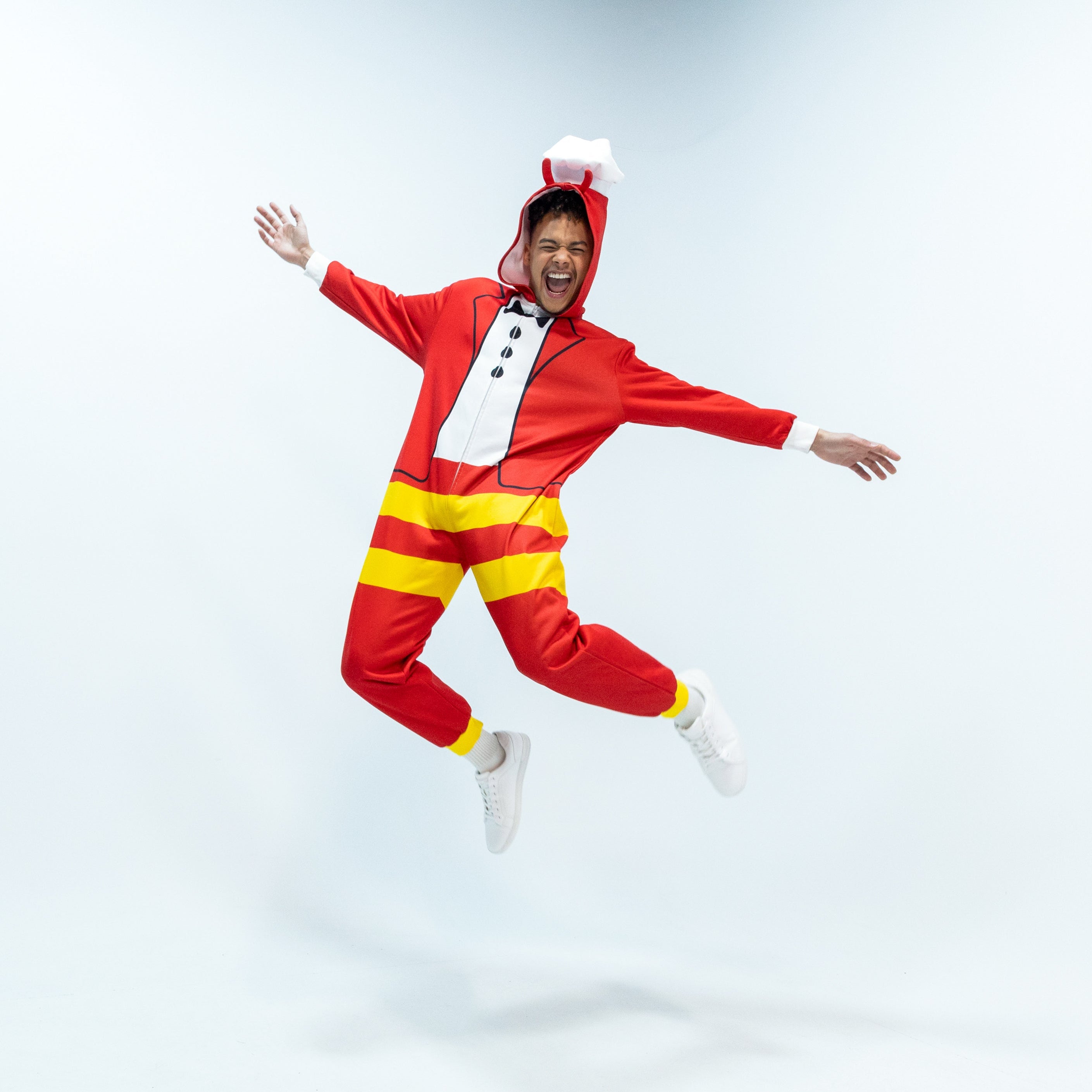 Person wearing a Jollibee red and yellow onesie on a white background