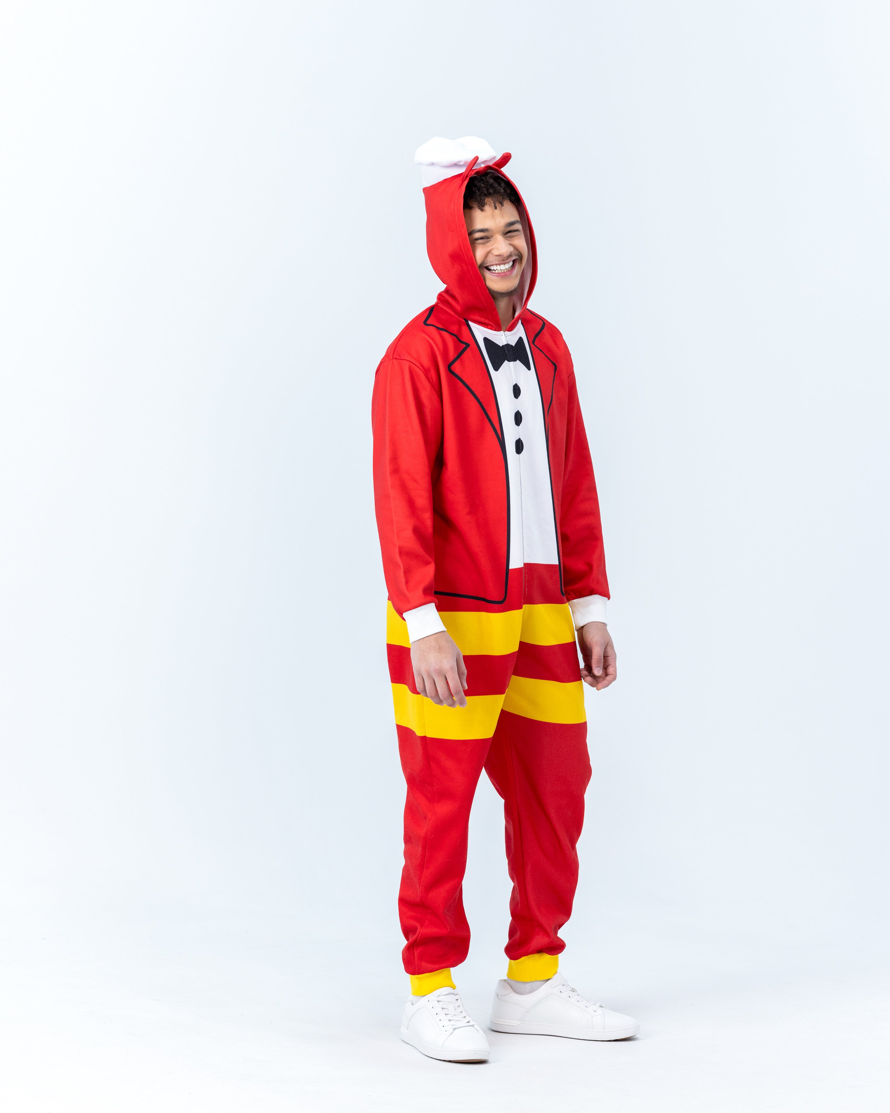 Person wearing a Jollibee red and yellow onesie on a white background